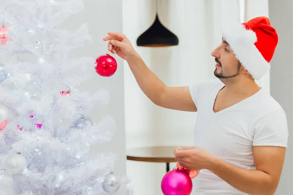 Άντρας με το καπέλο του Άι Βασίλη ντύνεται σαν χριστουγεννιάτικο δέντρο — Φωτογραφία Αρχείου