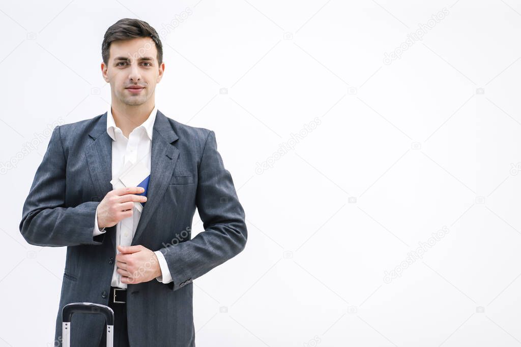 Businessman taking travel documents out of the inner pocket of his jacket.