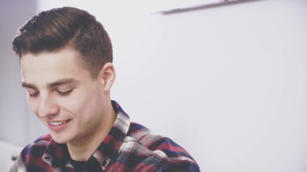 Adorable boy is sitting at the table in cafe. He is communicating with his girlfriend. Sincere smile. Close up. Copy space. — Stock Video