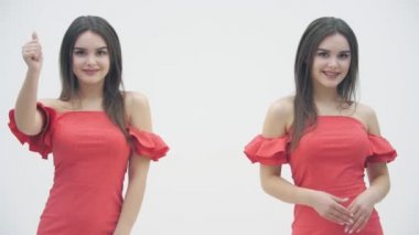 Aynı kırmızı elbiseli iki ikizin beyaz arka planda el çırpışları ve el çırpışları..