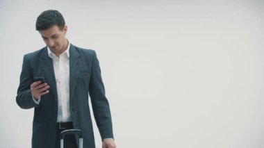 4K video 'da yakışıklı bir genç adam uçağını beklerken telefonda konuşuyor..
