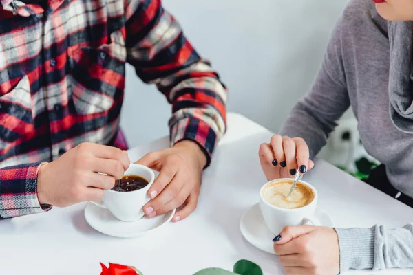 Cropped shot of couple on date, man drinks strong espresso, woman cappuccino. Aroma and flavor beverage. — Stock Photo, Image