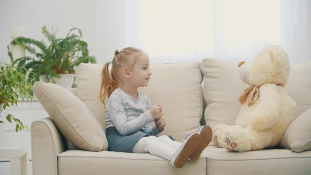 4k βίντεο του μικρού κοριτσιού που έχουν συνομιλία με βελούδινα παιχνίδι. — Αρχείο Βίντεο