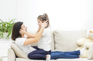 Annenin kızıyla kanepede oynarken çekilmiş bir fotoğrafı..