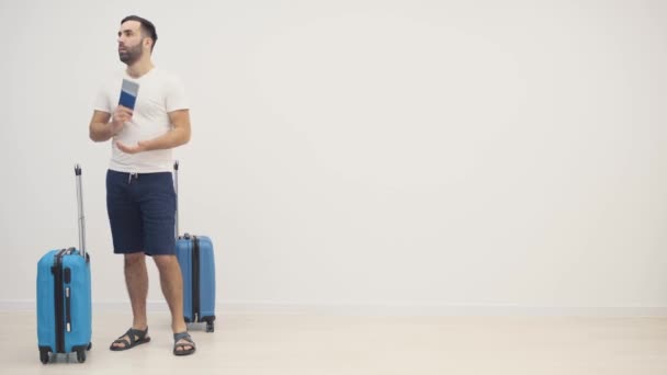 4k slow motion vídeo of young man ready for the trip with his suitcase packed over white background. — Vídeo de Stock