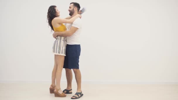 4k slowmotion video of cheerful young couple with tickets hugging. — Stock Video