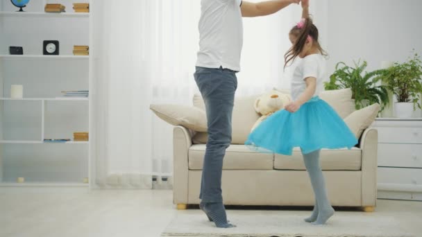 Father is dancing with his daughter. Little ballerine is dancing around. — Stock Video