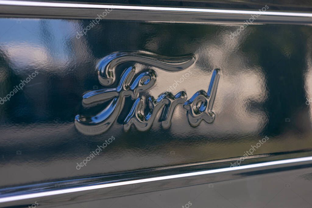 Poznan, Poland - August 31, 2025: Close-up of the Ford brand emblem, an iconic symbol of quality, reflecting light on a dark automotive surface, conveying strength and design