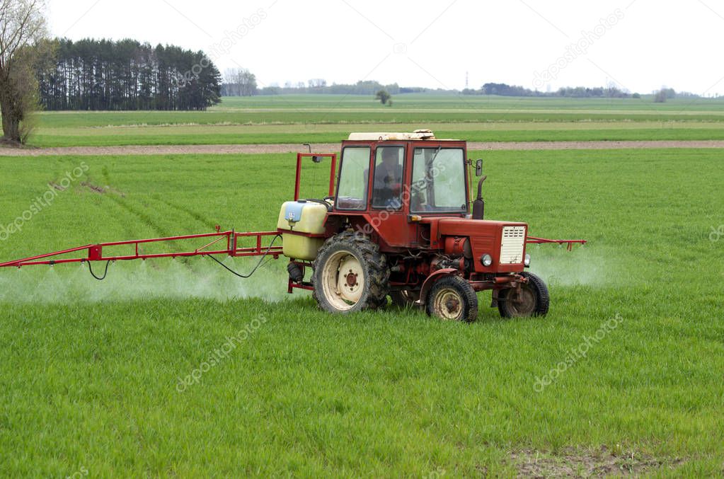        Agricultural machinery works on a spring field.  