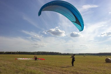 Moto yamaç paraşütü yerde ve havada.