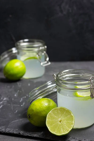 lime juice in glasses on dark stone