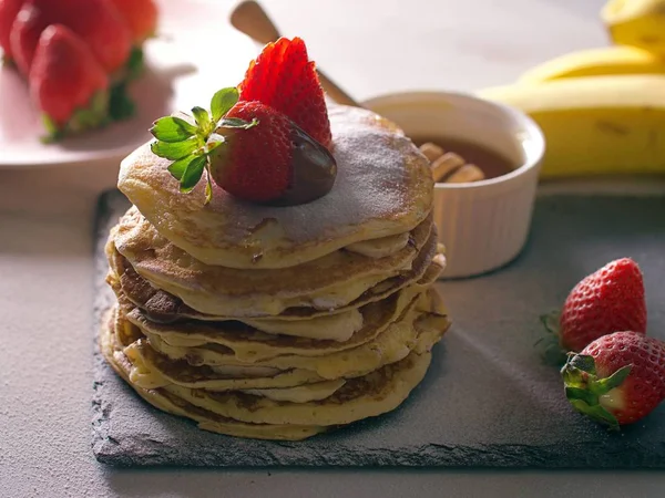 American pancakes with chocolate strawberries and banana Stock Picture