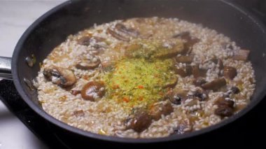 Mantar ile pişirme risotto ve kuru et suyu tozu ekleyerek. Yavaş çekim