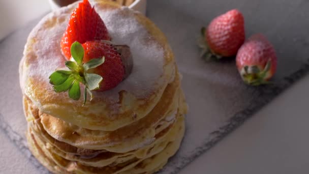 American pancakes with chocolate strawberries and banana. Top View — Stock Video