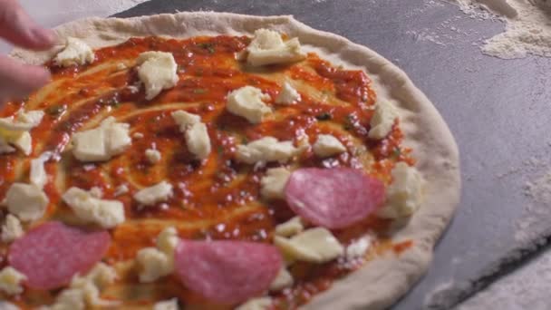 O chefe põe salame na pizza. Movimento lento — Vídeo de Stock