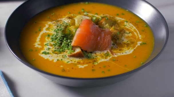 Añadir salmón a la sopa de calabaza crema — Vídeo de stock