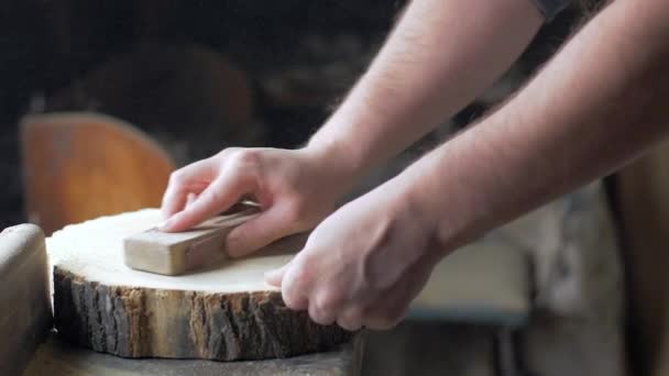 Carpenter polishes the wooden board with sandpaper on desktop. — Stock Footage Carpenter polishes the wooden board with sandpaper on desktop. Video Clip