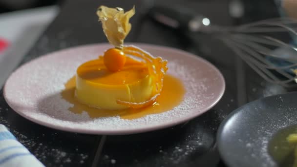 Very delicious dessert. Creme brulee with caramel and powdered sugar. — Stock Video