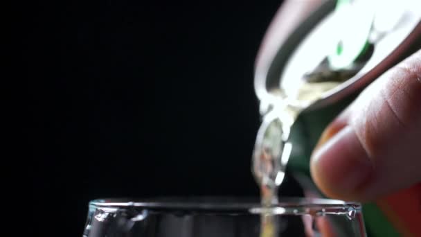 Pouring Cold Beer into a glass with water drops. Can of Beer close up. — Stock Video