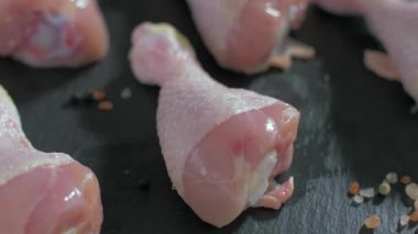 Çiğ tavuk bacakları tuz biber ve biberiye ile tatlandırılmış