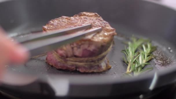 Preparing steak filet mignon with butter and rosemary — Stock Video