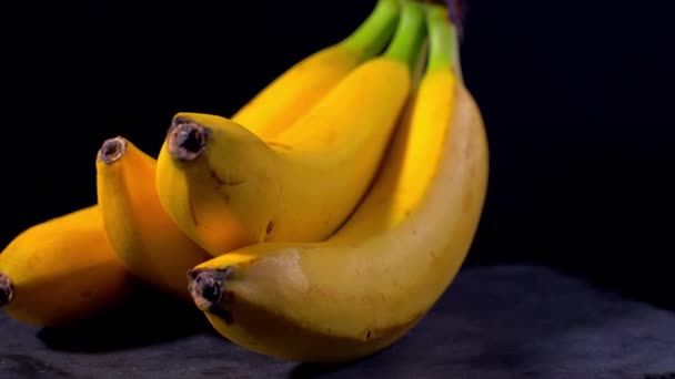 Bananas em um fundo preto — Vídeo de Stock