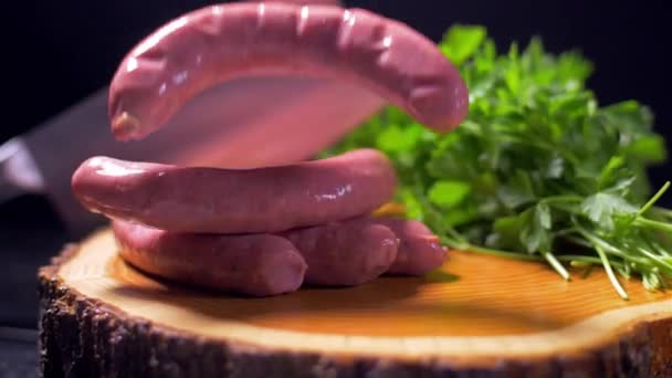 Les saucisses crues tombent sur la planche de bois — Video