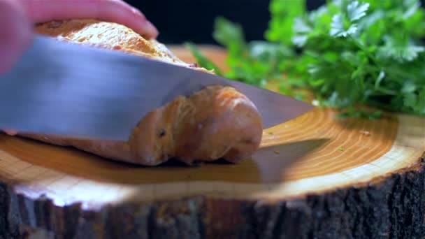 Vue rapprochée de trancher du pain sur une planche à découper en bois . — Video