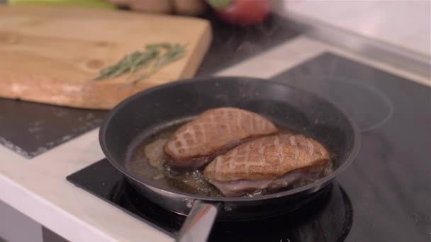 The chef prepares duck breasts in a pan — Stock Video