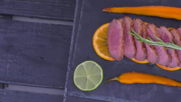 A dish of duck breasts on an orange sofa. Well-baked duck. — Stock Video