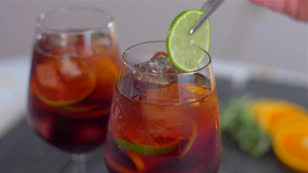 Decorating cocktail sangria with lime — Stock Video