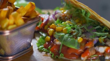 Lezzetli Meksika gıda burrito ve kızarmış patates ahşap bir tahta üzerinde servis
