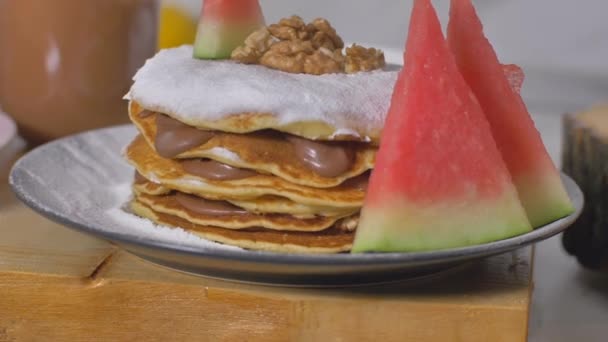 Decorating American pancakes with juicy watermelon and walnuts — Stock Video