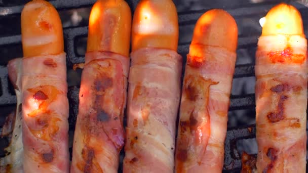 Grilled sausage with bacon. Sausages with bacon fried on the grill — Stock Video