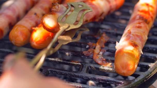 Grilled sausage with bacon. Sausages with bacon fried on the grill — Stock Video