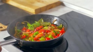 Aşçı tavada sebze karıştırır. Yavaş çekim 