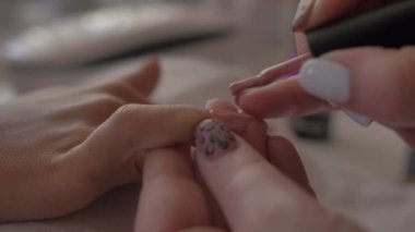Kadın jöle lekelerini manikür makinesiyle temizliyor. Kendi başına manikür yapıyor. Kendi kendine yapılan manikür hizmeti