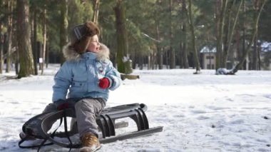 Karda kızakla çocuk. Aktif eğlence aile Noel tatili için