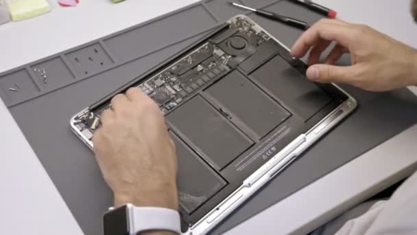 Inženýr opraví vody k poškození notebooku. Inženýr extrahovat baterie přenosného počítače — Stock video