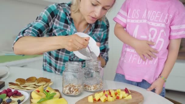 Jonge Kaukasische vrouw met kind maken chia pudding — Stockvideo