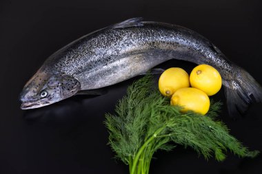 Limon ve siyah bir zemin üzerine dereotu taze somon