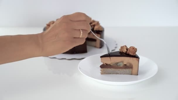 Close up of female hand cutting chocolate glaze mousse cake. — Stock Video