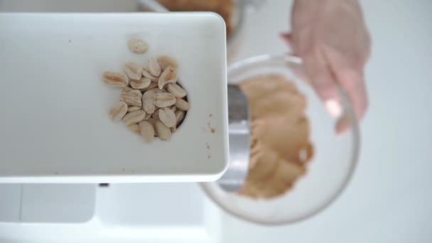 Woman prepare peanut butter mincing machine — Stock Video