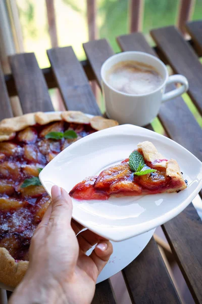 Plum tart with cinnamon. Portion of cake on a plate with shallow depth of field.