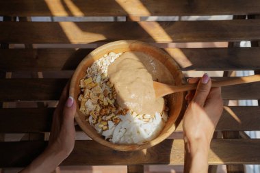 Granola, pişirme işlemi, sağlıklı kahvaltı fikir, vegan diyet ve detoks kavramı hazırlanması.
