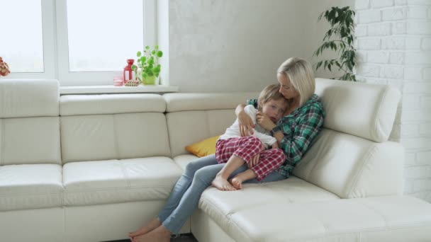 Mãe medir a temperatura de seu filho doente no fundo. Criança doente com febre alta deitada no sofá em casa — Vídeo de Stock