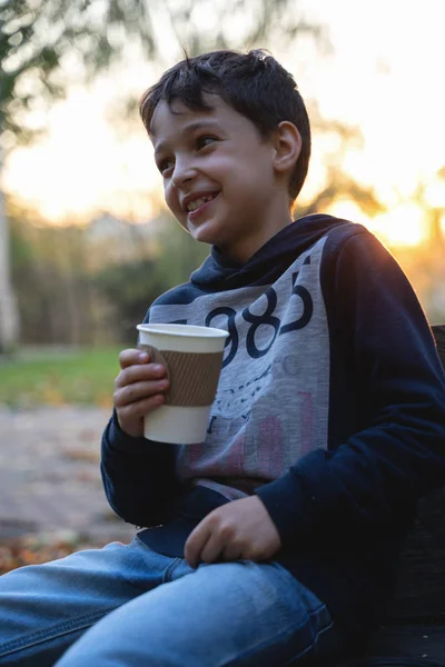 Boy holds cup in hands on fallen leaves background. autumn mood beautiful day. Golden fall in still life. Bright Fall image. — Stock Photo, Image