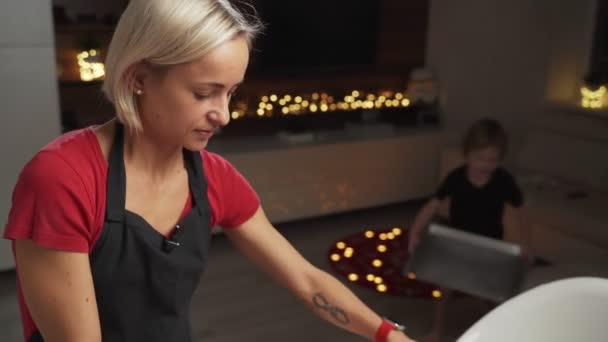 Mutter und kleiner Sohn bereiten sich auf Weihnachten vor, backen gemeinsam riesige Plätzchen — Stockvideo