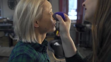 Profesyonel makyaj sanatçısı, iş fırça el closeup - güzellik moda endüstrisi kozmetik sahne arkasında profesyonel makyaj - yan makro görünümü güzel doğal ışık Studio windows ile