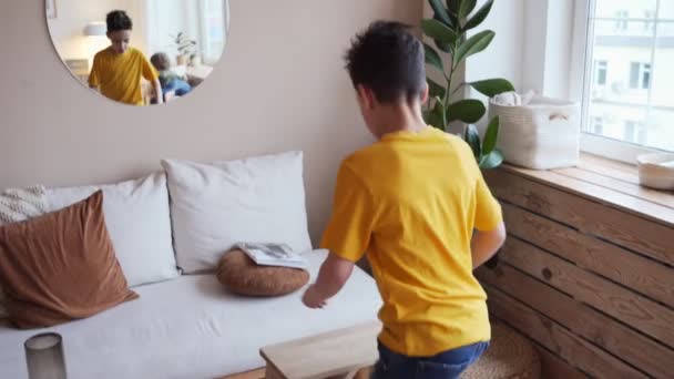 Niño confiado mirando sus músculos en el espejo imaginando que él es súper héroe — Vídeo de stock